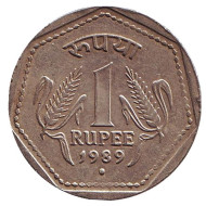 Монета 1 рупия. 1989 год, Индия. ("°" - Ноида, гурт - рубчатый с желобом). Монета 1 рупия. 1989 год, Индия. ("°" - Ноида, гурт - рубчатый с желобом).