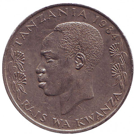Монета 1 шиллинг. 1984 год, Танзания. Президент Али Хассан Мвиньи. Факел.